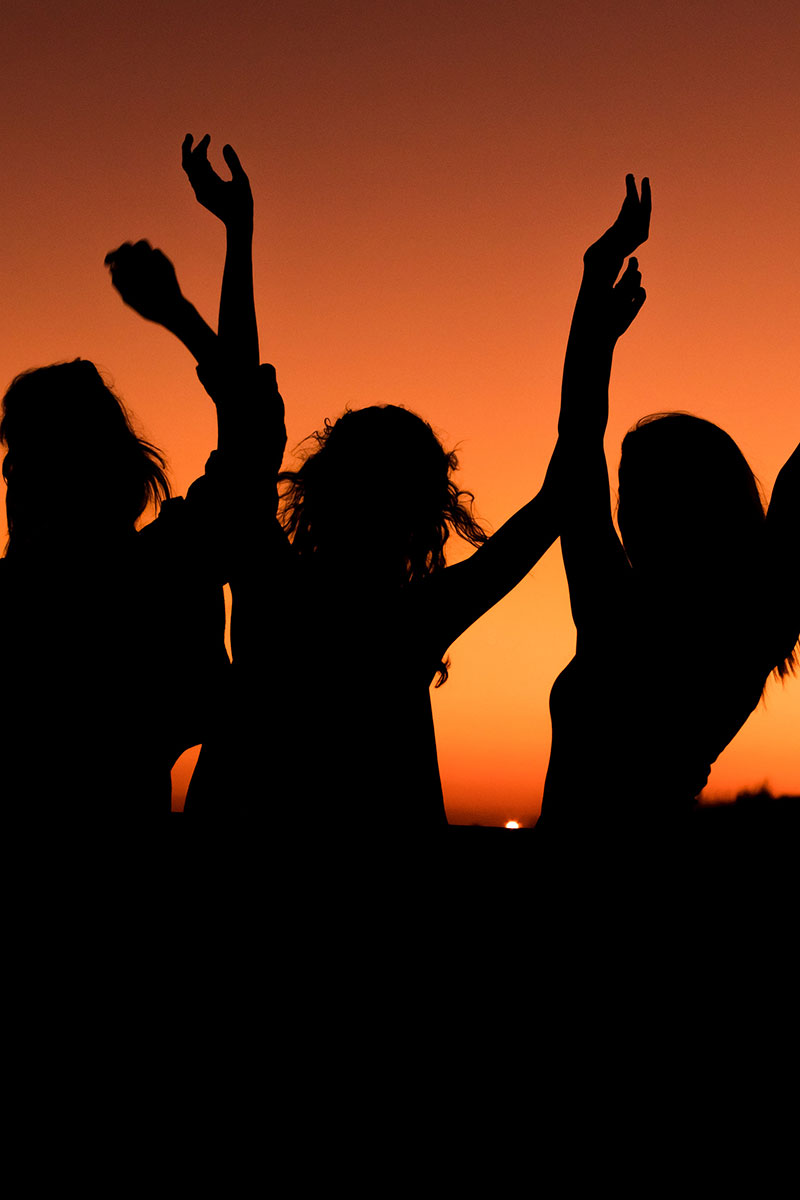 Group of women reaching up - silhouette